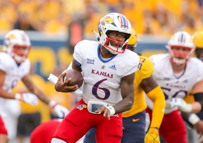 Sep 10, 2022; Morgantown, West Virginia, USA; Kansas Jayhawks quarterback Jalon Daniels (6) runs the ball during the first quarter against the West Virginia Mountaineers at Mountaineer Field at Milan Puskar Stadium. Mandatory Credit: Ben Queen-USA TODAY Sports